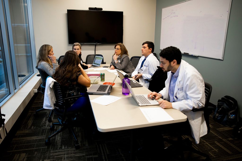 Professionals sitting around a conference table working