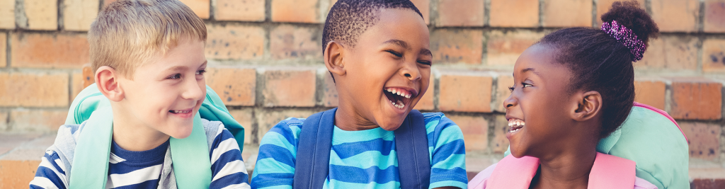 Kid laughing with a backpack on