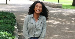 Women standing outside smiling
