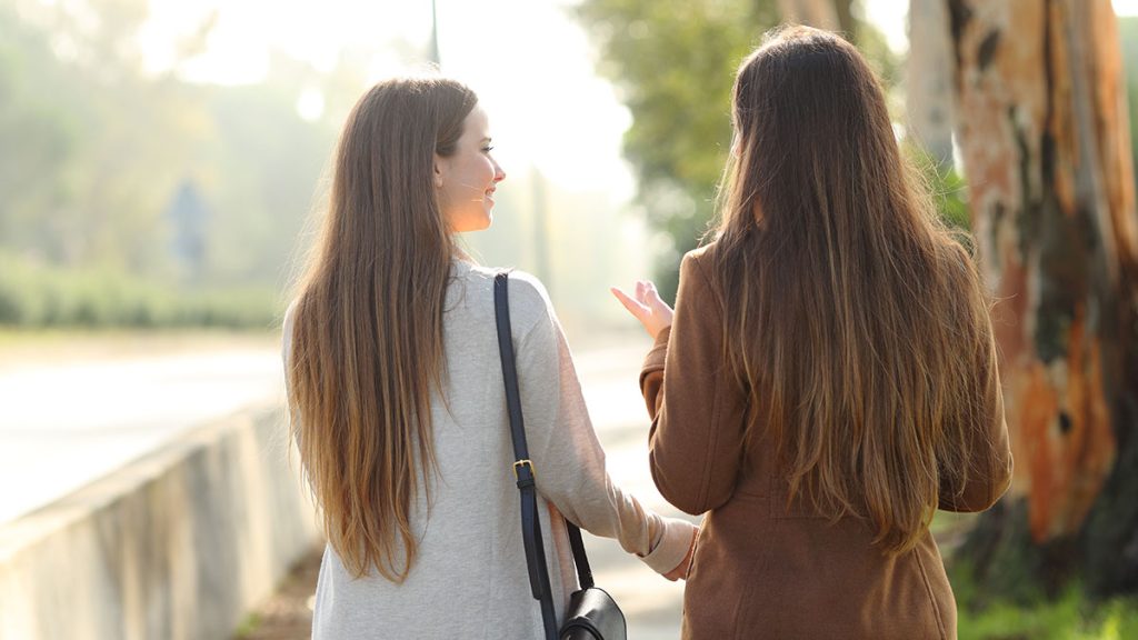 Two people walking next to each other