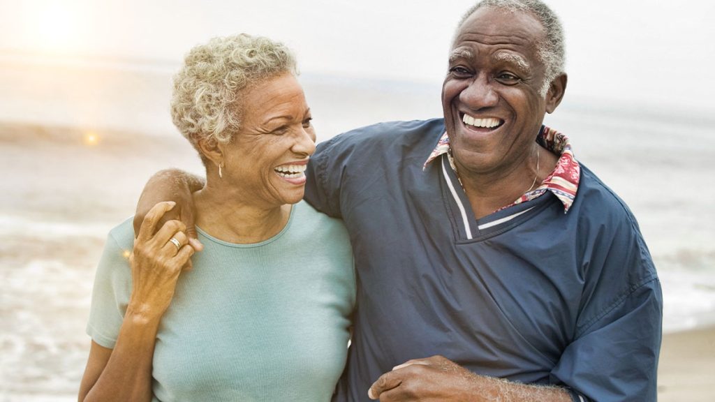Elderly couple arm-in-arm smiling