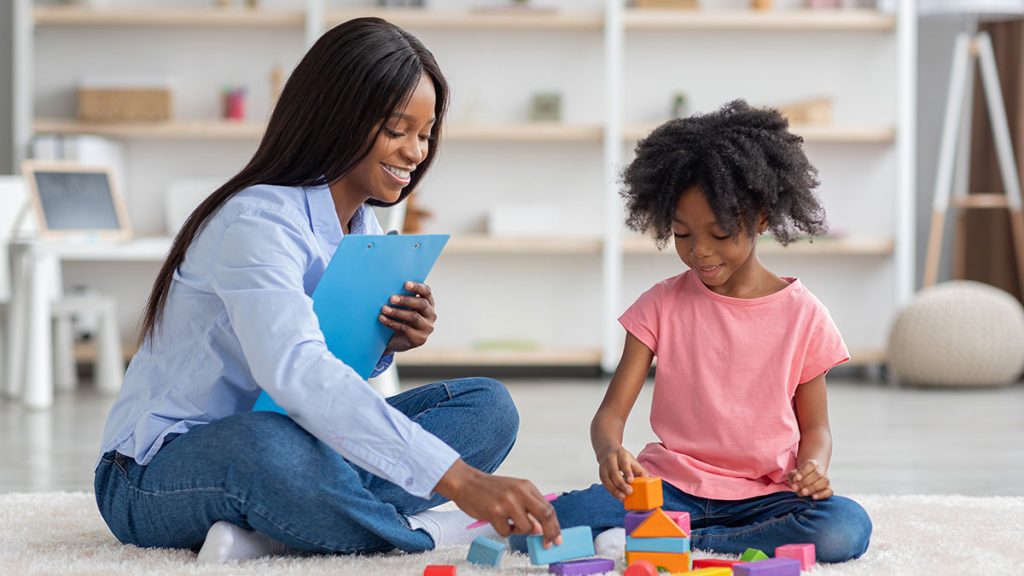 Woman and child stacking blocks