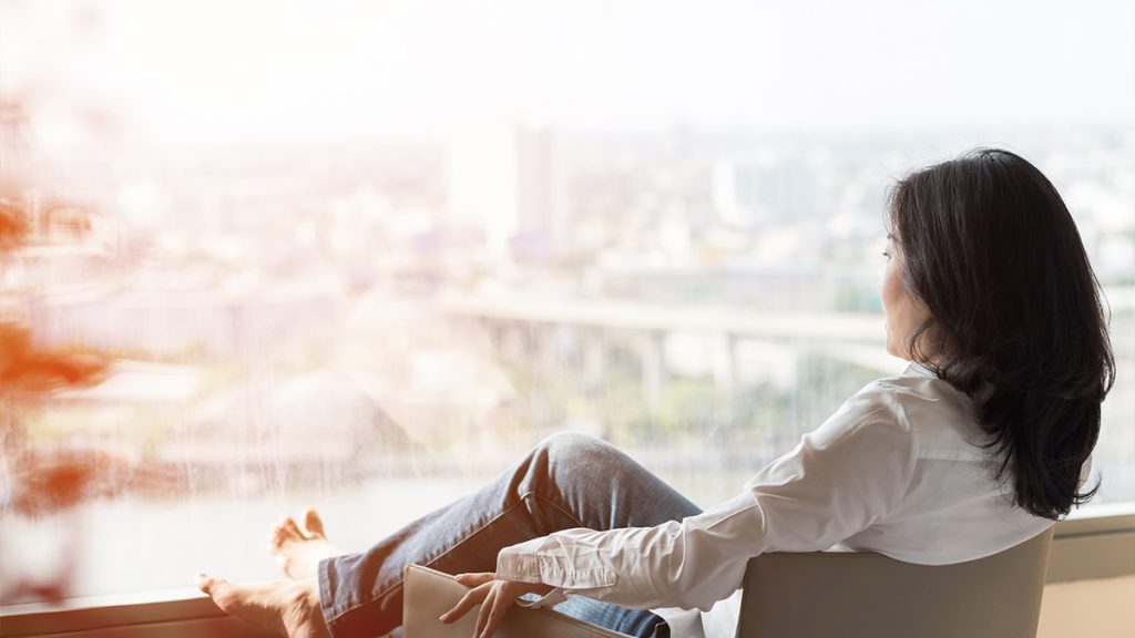 Woman sitting looking out a window