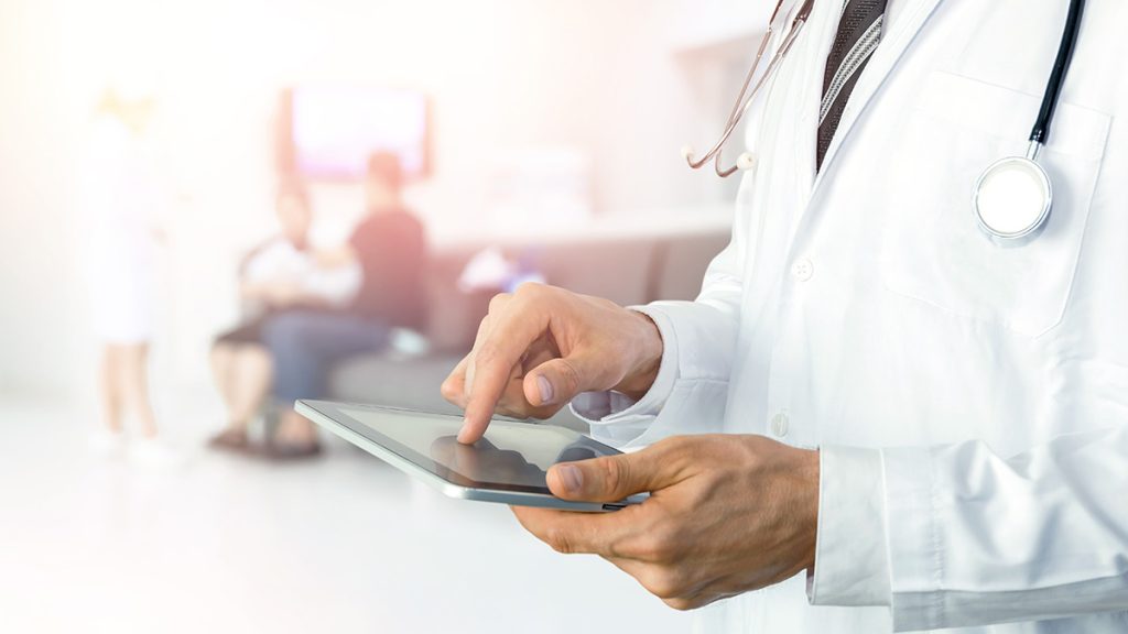 Doctor tapping on a tablet