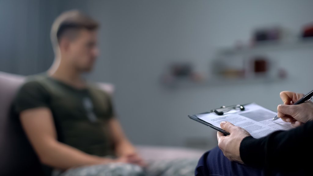 Writing on a clipboard while talking to someone