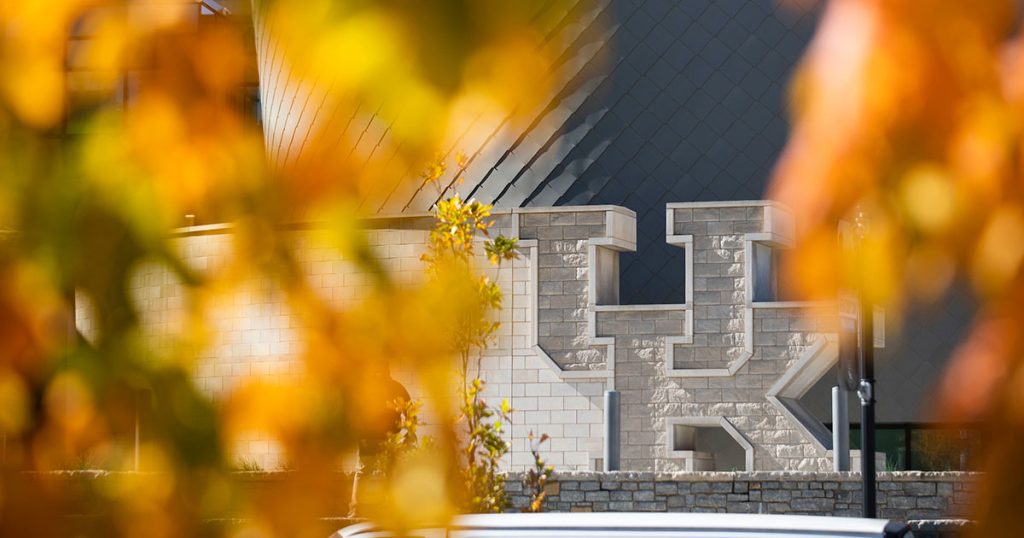 Fall foliage in front of stone UK at Gatton Student Center