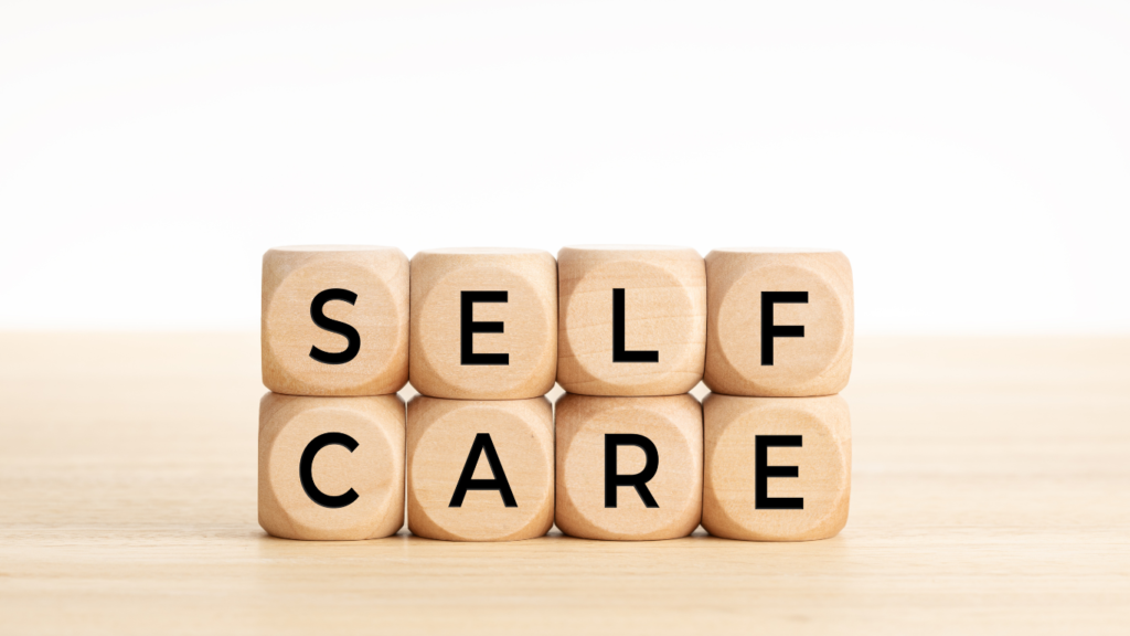 the words "SELF CARE" written on scrabble blocks