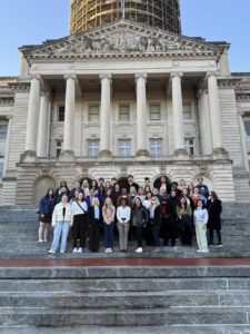 Students stand on steps in front of KY Capitol