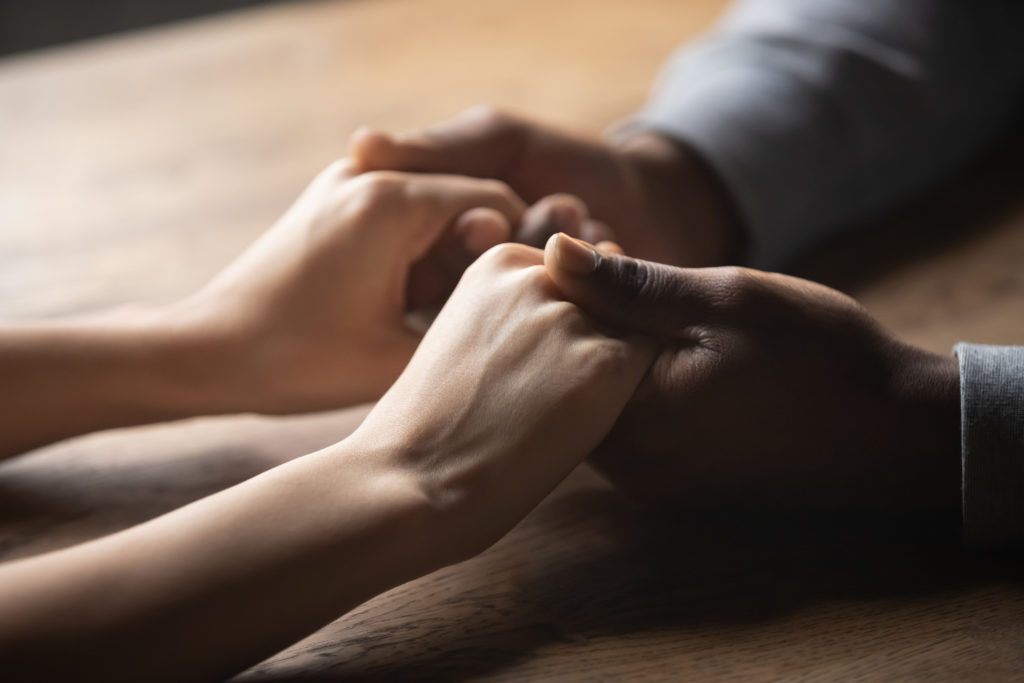 Close up of two people holding hands