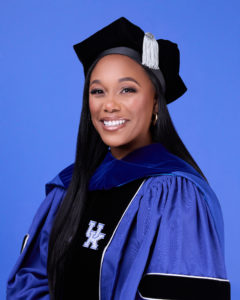 Photo of Kayla Gill in graduation regalia
