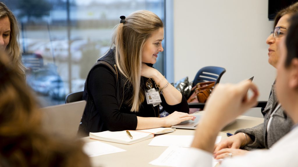 Medical, pharmacy, and social work students collaborating on clinical care for UKnow.