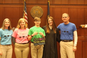 The Hurt-Mueller family with a judge following the adoption of their son, Will.