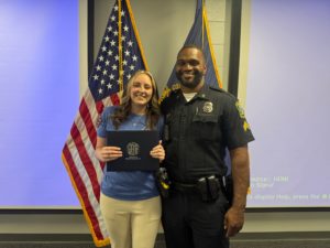 Tiffany Malicote holding with Sergeant Donald Horton at the Lexington Community Police Academy