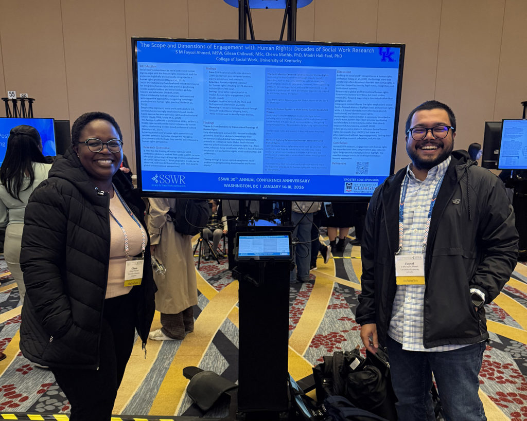PhD students Gilean Chikwati and Foysel Ahmed in front of their poster presentation at the 2026 SSWR Conference