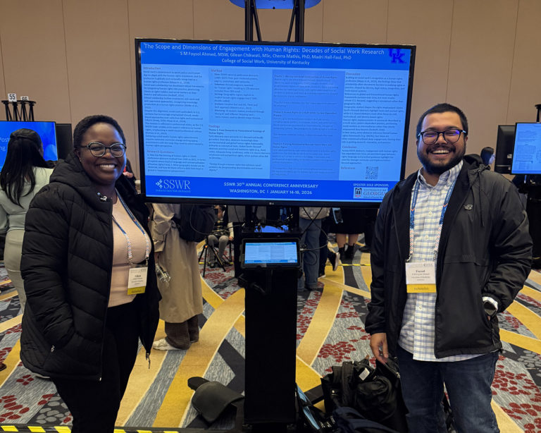 PhD students Gilean Chikwati and Foysel Ahmed in front of their poster presentation at the 2026 SSWR Conference