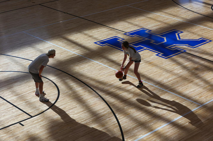 Two people playing basketball in the UK Johnson Center