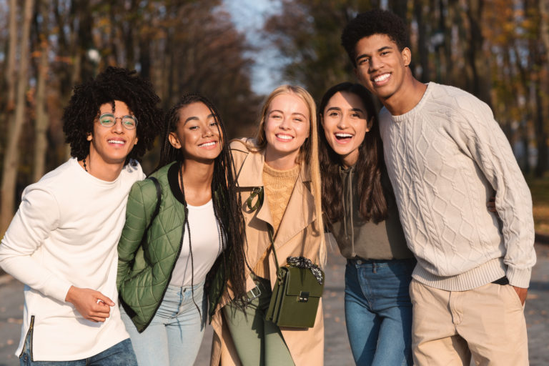 Group of teenagers posing together and smiling