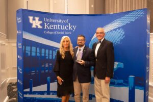 Shawn Hunter poses with his award and family at 2025 College of Social Work Annual Recognition Awards