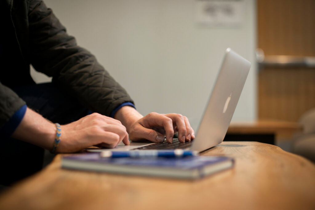 Image of someone working on their laptop