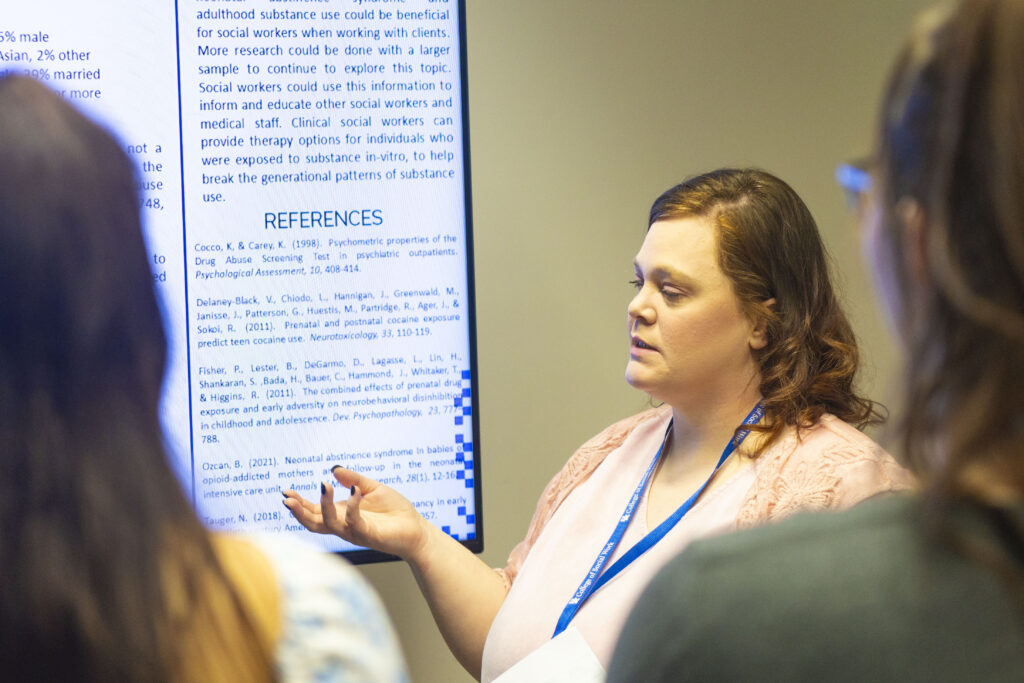 Social work student presents during the KASSW 2024 conference at William T. Library