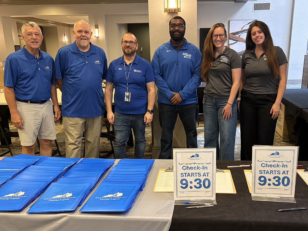 UK College of Social Work Staff standing at the Medically Complex Training registration table
