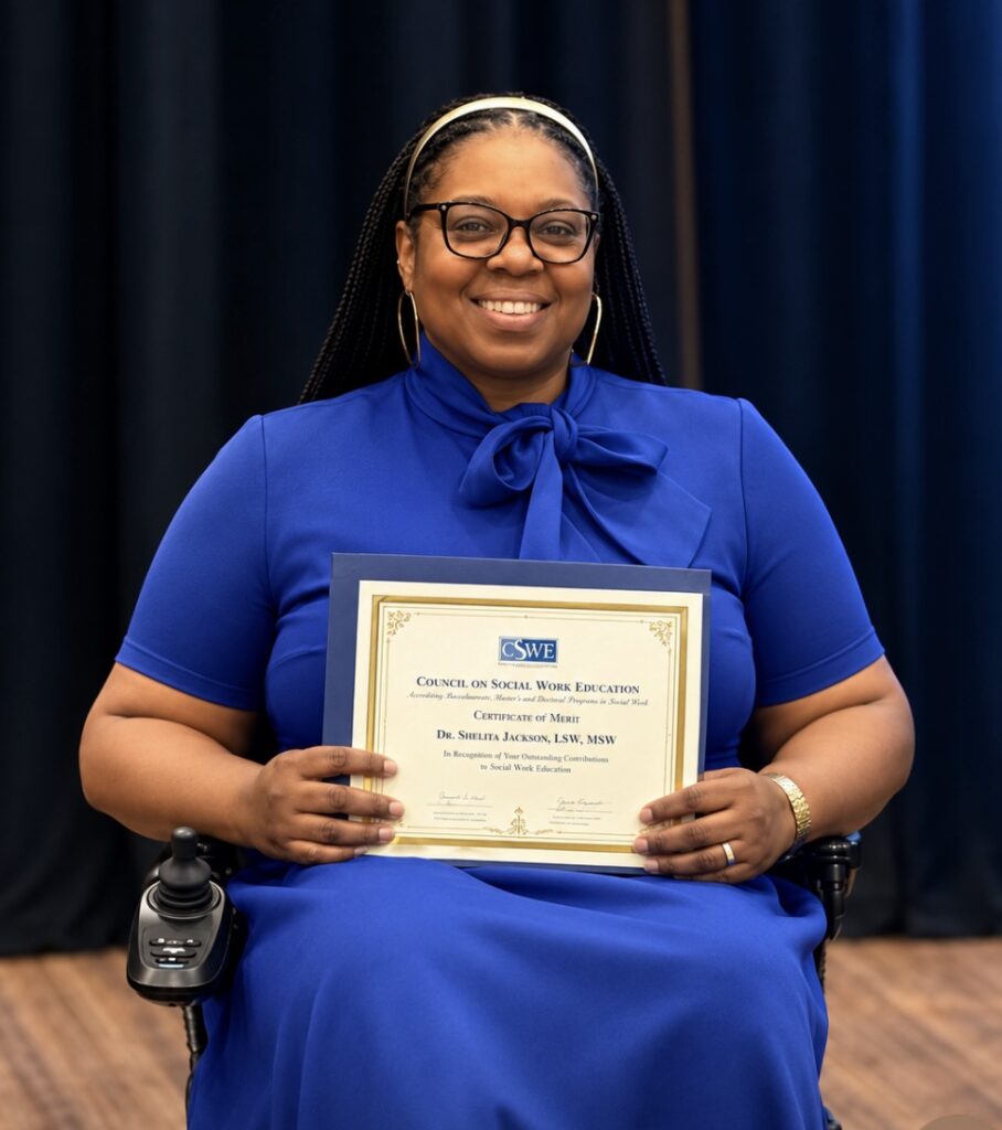 Dr. Shelita Jackson holding up award from CSWE