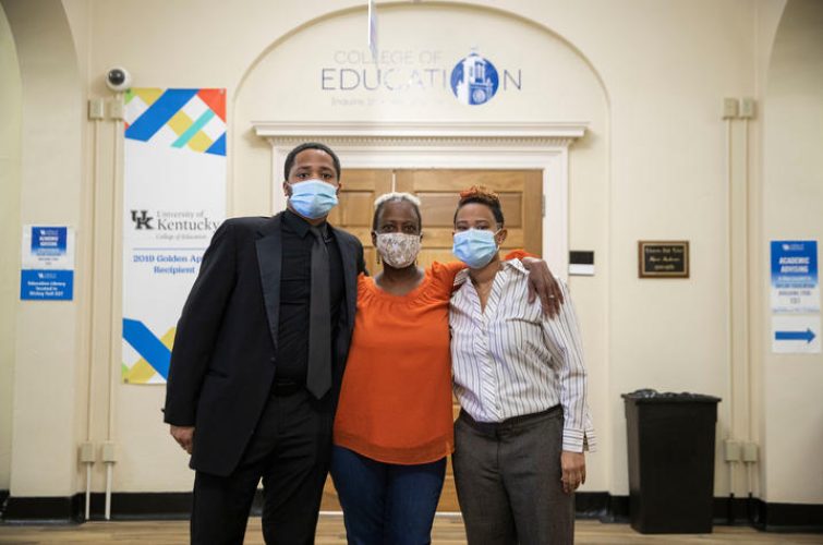 Taylor and Tyler Henderson, the grandchildren of Mary Henderson, the first black graduate from UK with their mother at the Taylor Education Building on February 9, 2022. Photo by Pete Comparoni | UKphoto