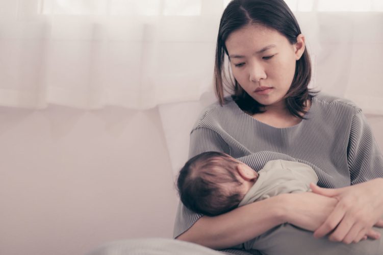 Tired Mother Suffering from experiencing postnatal depression.Health care single mom motherhood stressful.