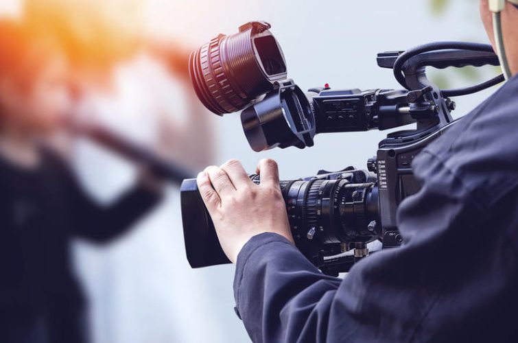 Video camera operator working with his equipment