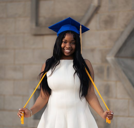 Jordin Williams standing outside the Gatton Student Center in her graduation cap and cords.